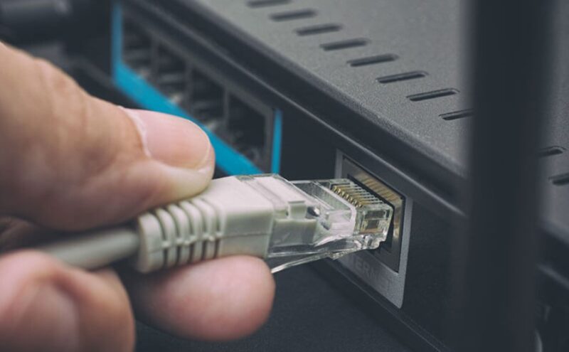 Close up of a hand holding ethernet cable