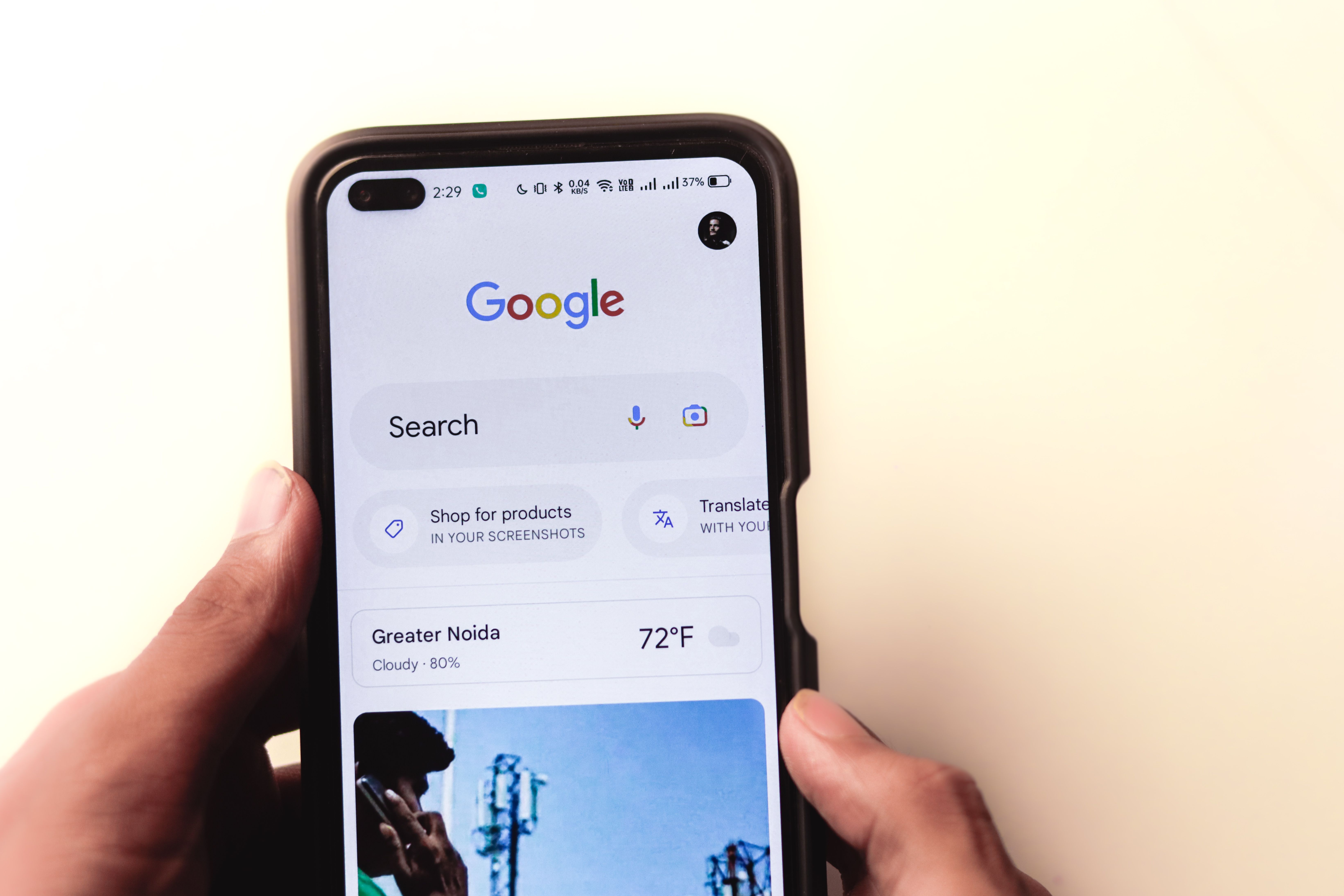 Hand holding a smartphone showing a Google search for local businesses