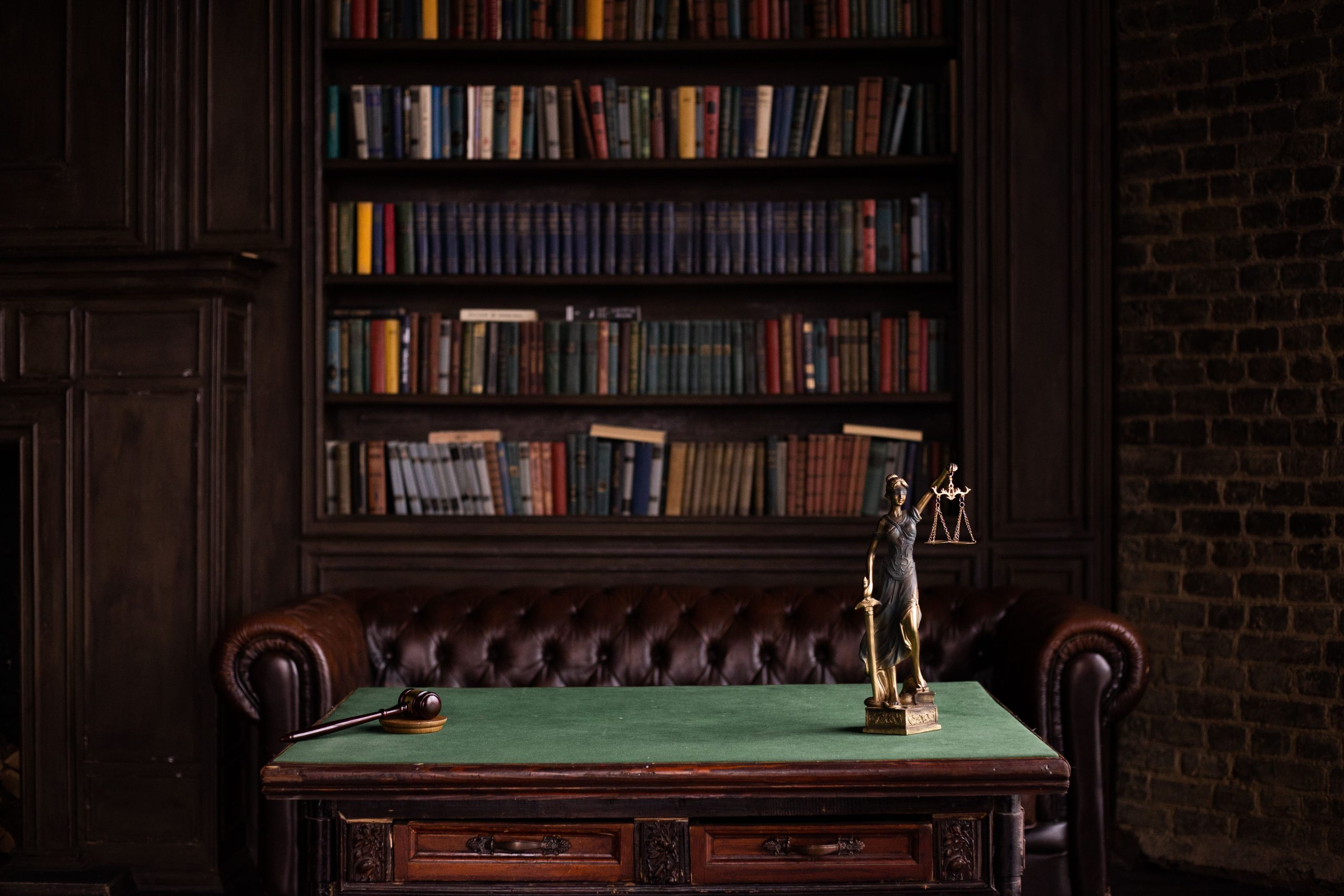Classic law library study with gavel and Lady Justice figurine, symbolizing large-scale litigation